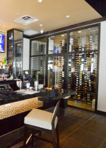 This contemporary commercial custom wine cellar in Las Vegas, Nevada displays the wines in metal wine racks.