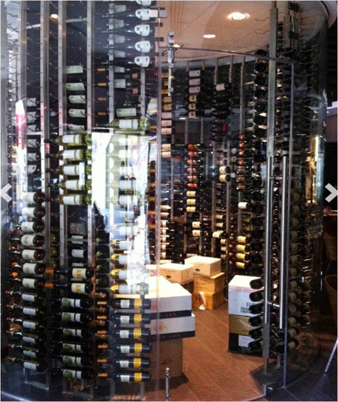 Learn how we design and build commercial custom wine cellars. Glass-Enclosed Glass Commercial Wine Cellar with VintageView Custom Wine Racks Built by Trusted Las Vegas Installers