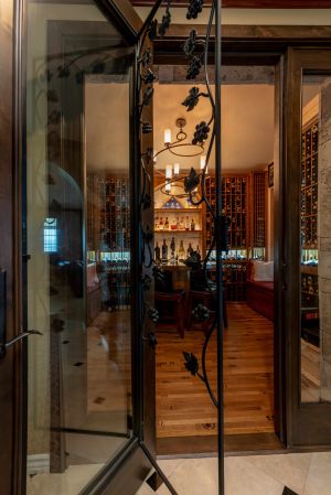 7 - Alderwood Door with Grapevine Operable Grill in a Residential Wine Cellar