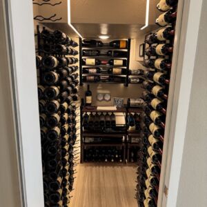 2 - Proof that a small wine cellar can pack big impact. This closet conversion features dual-sided wall racks, a custom wooden centerpiece, and seamless design from floor to ceiling.