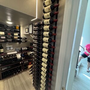 5 - This wall-mounted wine rack keeps the collection both visible and accessible. Vertical symmetry and recessed lighting make even narrow spaces feel expansive.