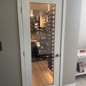 1 - Behind the glass: A modern small wine cellar tucked neatly into a closet space. The wood-framed, dual-paned door keeps the cool air in—and the wine on perfect display.